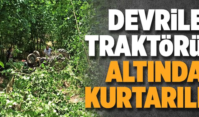 Devrilen traktörün altından kurtarıldı